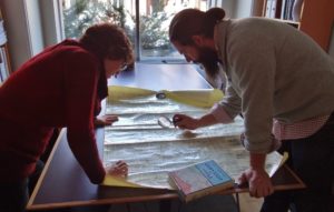 Caleb and Cultural Heritage Manager Annie examining a historical map of the city. 