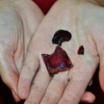 Close up of the blood red glass vial fragment.