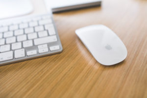 White Apple mouse and keyboard on a wooden desk - kaboompics.com